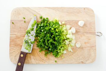 Spring onion on a cutting board with knife