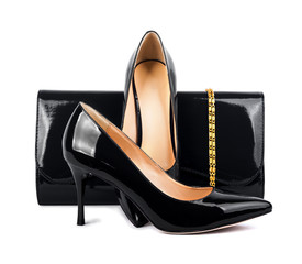 Beautiful  black shoes with clutches on white isolated backgroun