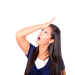 Fototapeta premium Portrait of young woman slapping hand on head having a duh momen