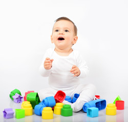 Beautiful baby girl with colorful toys - Studio shot