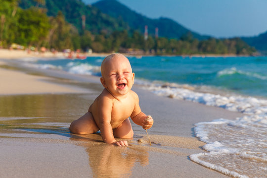 A little kid having fun on a tropical beach.