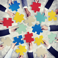 Group of Hands Holding Colorful Jigsaw Pieces
