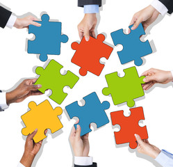 Group of Hands Holding Jigsaw Puzzle
