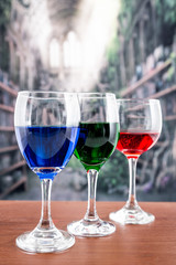 Glasses with blue red and green liquid cocktails