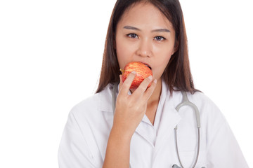 Young Asian female doctor eat apple