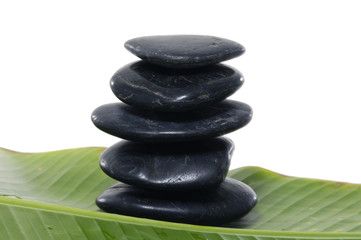 Stacked stones with green banana leaf