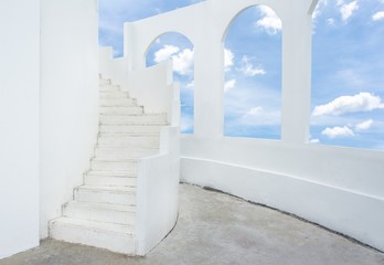 white spiral staircase and arch window