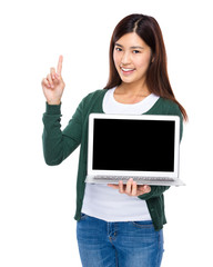 Woman show with blank screen of laptop computer and finger point