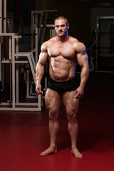 Fototapeta na wymiar Serious BodyBuilder Standing In The Gym