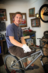 Portrait of smilng craftsman in bike workshop