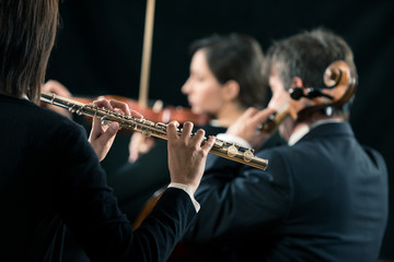 Symphony orchestra performance: flutist close-up