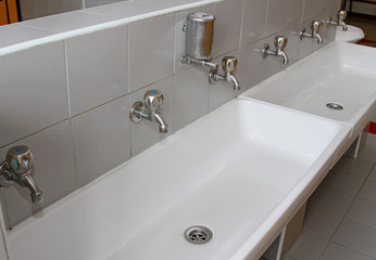 sinks and washbasins with taps in the toilets of a nursery