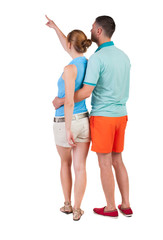 young couple pointing.