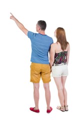 young couple in short pointing at wal