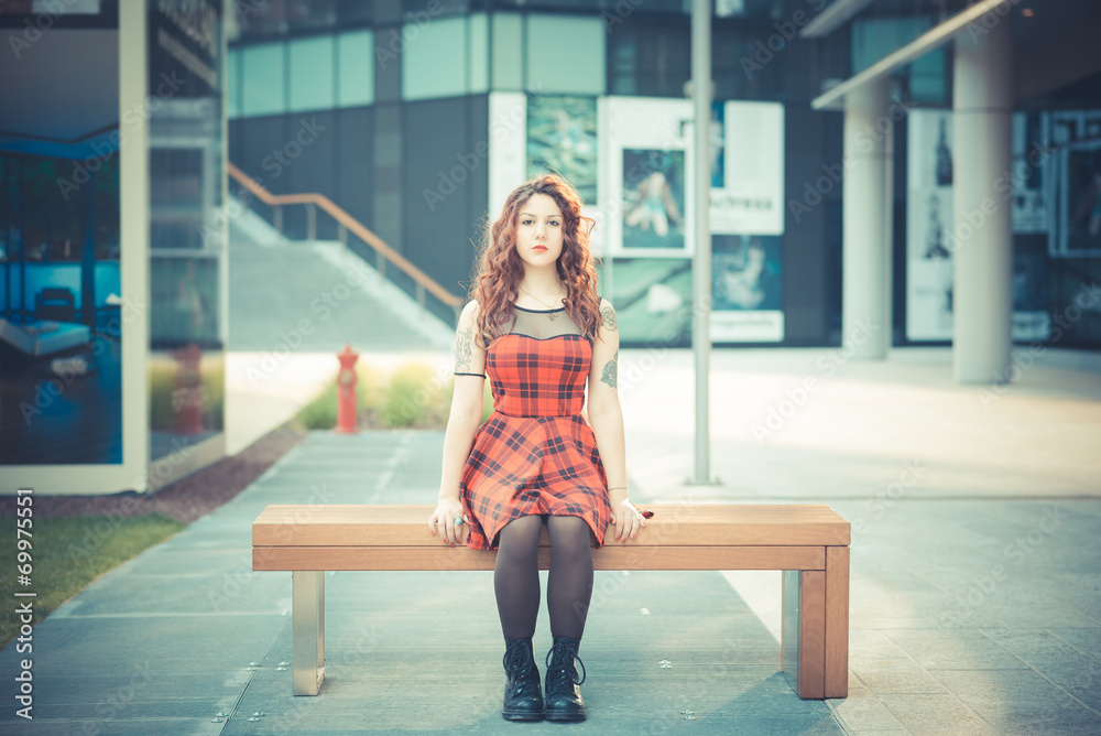 Wall mural young beautiful hipster woman with red curly hair