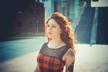 young beautiful hipster woman with red curly hair