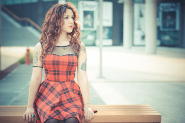 young beautiful hipster woman with red curly hair