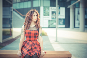 young beautiful hipster woman with red curly hair