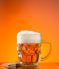 Glass of beer with orange background