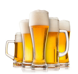 Collection of glasses of beer on white