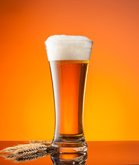 Glass of beer with orange background