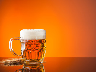 Glass of beer with orange background