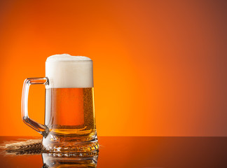 Glass of beer with orange background