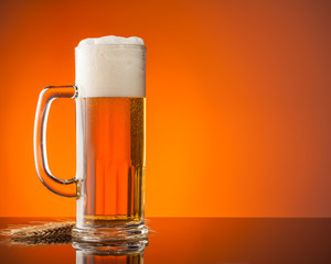 Glass of beer with orange background