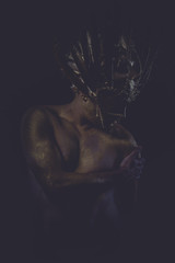 mythology golden bodypaint, man with gold helmet, ancient warrio