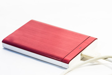 Red external hard drive with usb cable on the white