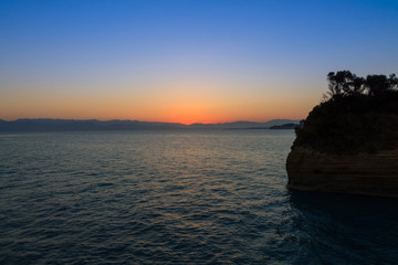 Fototapeta na wymiar Beautiful sunrise on the beach in Corfu