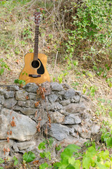 Acoustic guitar on a rock