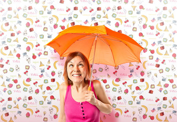 Girl holding an umbrella over colorful background
