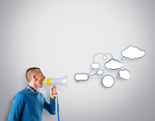 Redhead man shouting by megaphone over grey background