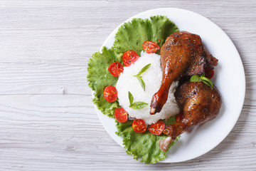 roasted duck leg with rice and vegetables top view horizontal