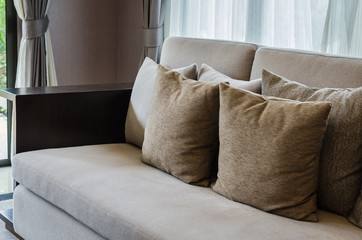 brown pillows on modern sofa