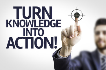 Business man pointing the text: Turn Knowledge Into Action!