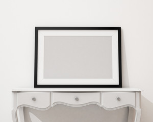 blank black picture frame on the white desk and wall