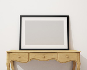 blank black picture frame on the white desk and wall