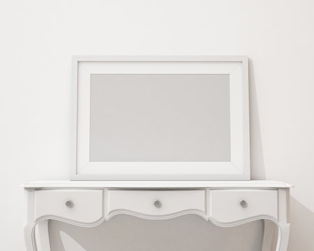 blank picture frame on the white desk and wall