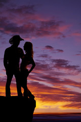 silhouette couple arm around cowboy