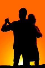 silhouette couple dance arms out
