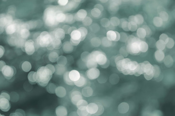 Obraz premium białe nieostre światła na turkusowym tle