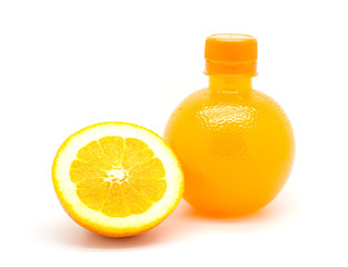 Orange slice and a bottle of fresh orange juice