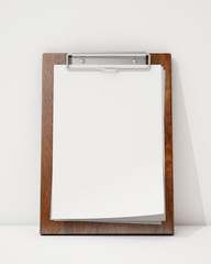 blank wooden clipboard ion the white wall and floor