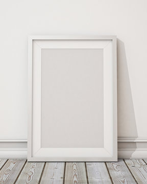blank white picture frame on the white wall and the wooden floor