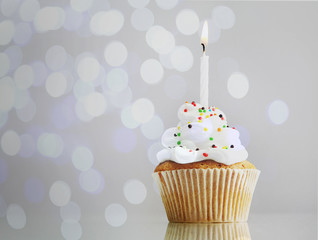 Tasty cupcake on bright background
