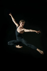 Fototapeta na wymiar young ballet dancer dansing on black background