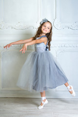A little adorable young ballerina in a playful mood in the inter © jutaphoto