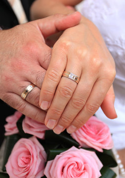 Wedding couple with ring on flower